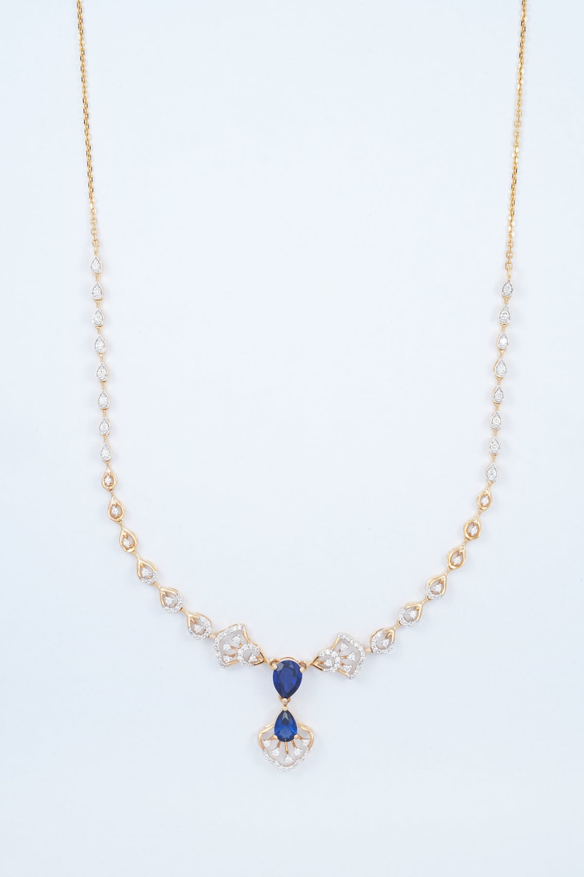18KT rose gold diamond necklace with blue gemstone drops and fan motifs