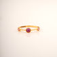 18KT gold ring with three pink gemstones set in a row