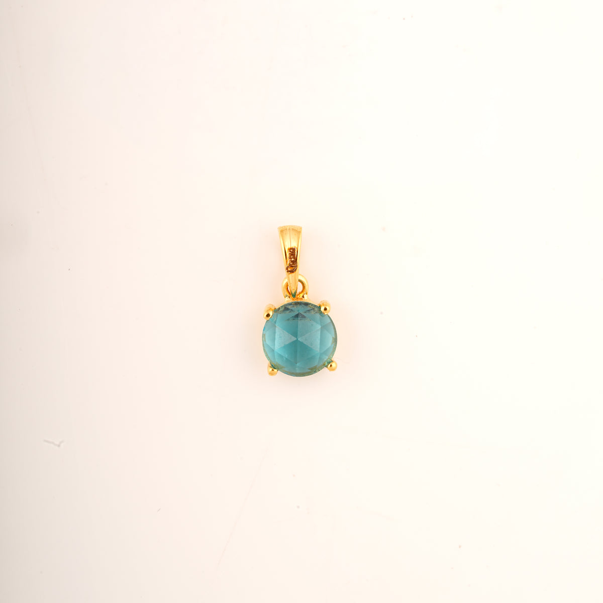 18KT gold pendant with round blue gemstone in claw setting