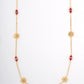 18KT gold necklace with pink gemstone stations and flower motifs