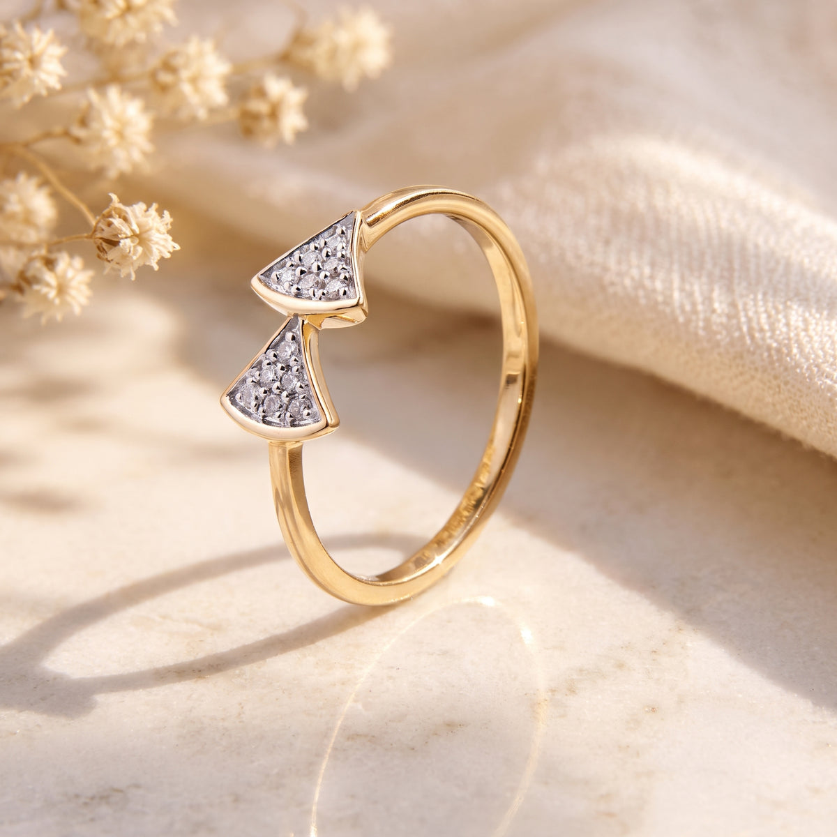 18KT gold diamond ring with two fan shapes forming a bow design