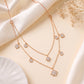 18KT rose gold diamond necklace with layered chains, star and round charms