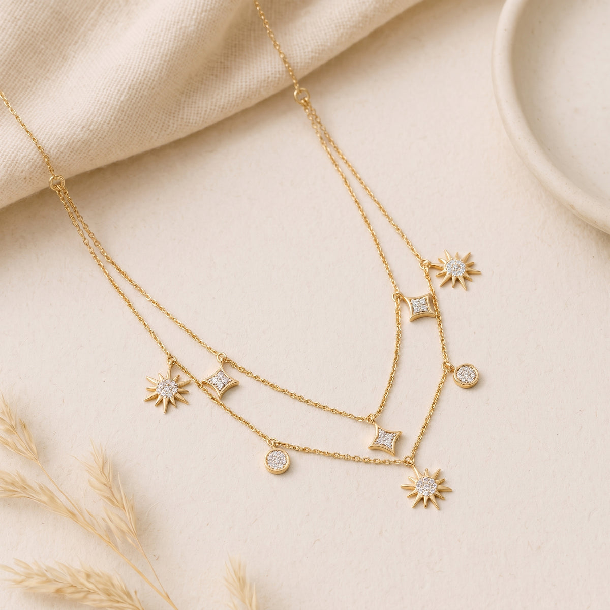18KT gold diamond necklace with layered chains, sunburst and kite charms