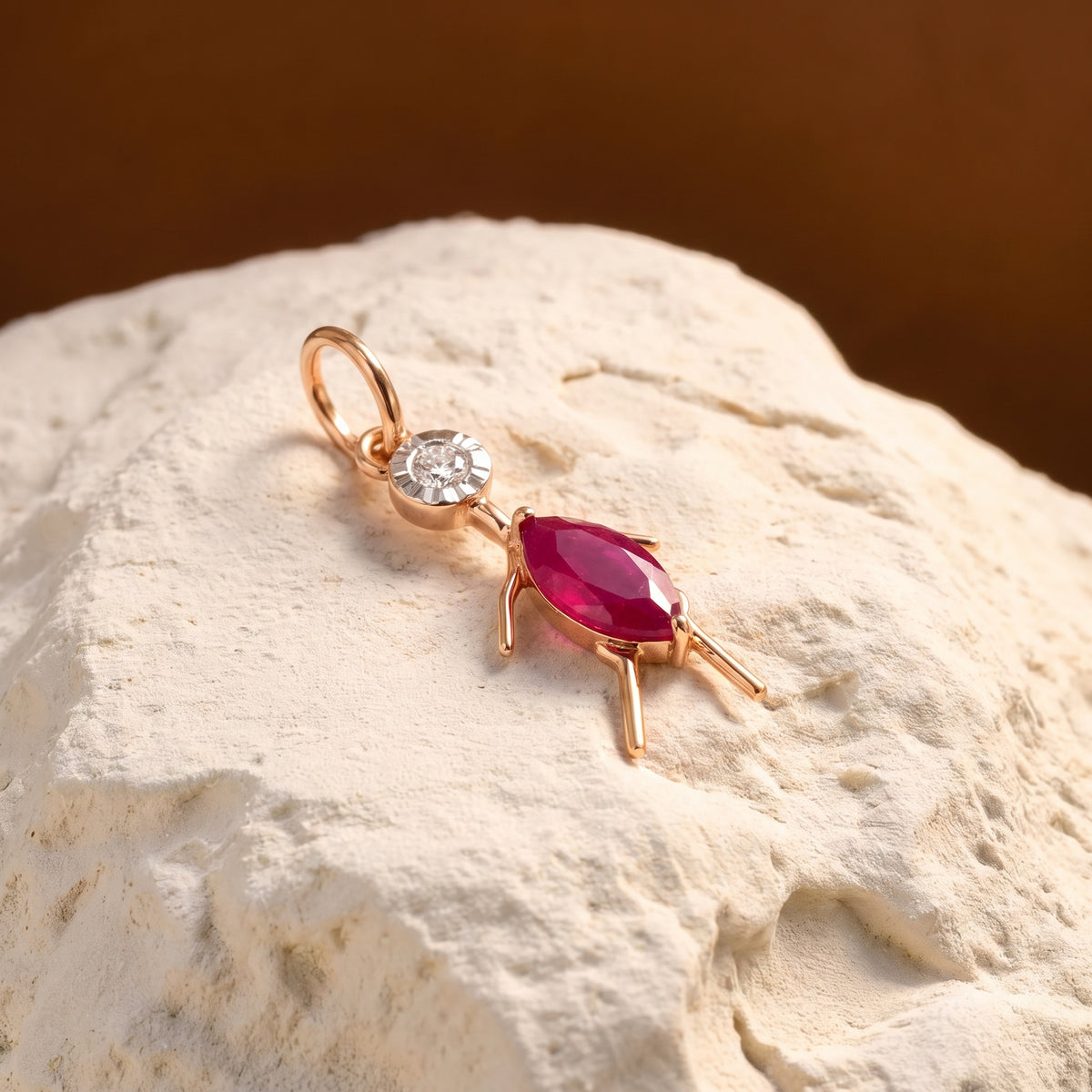 18KT gold pendant shaped like a girl with diamond head and pink stone dress