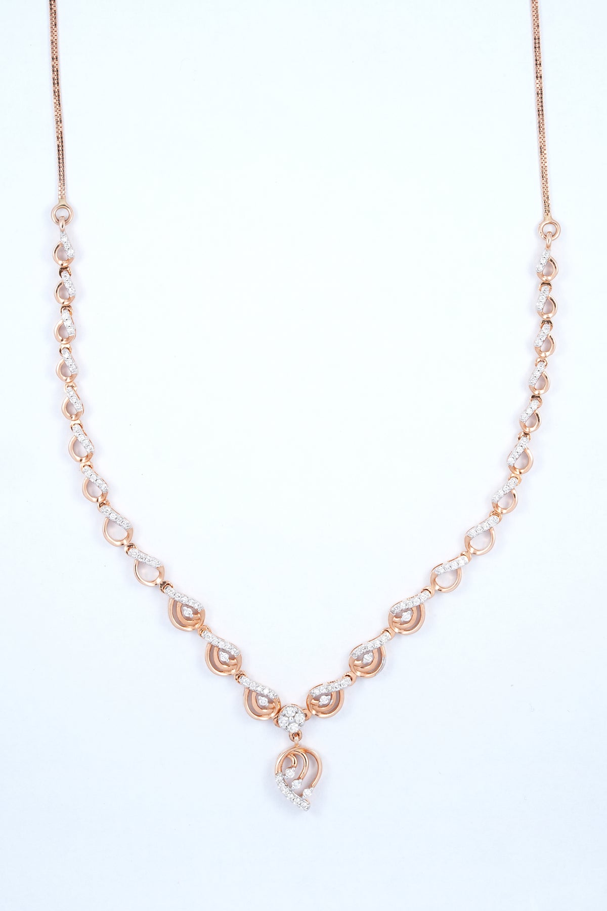 18KT rose gold diamond necklace with swirl link design