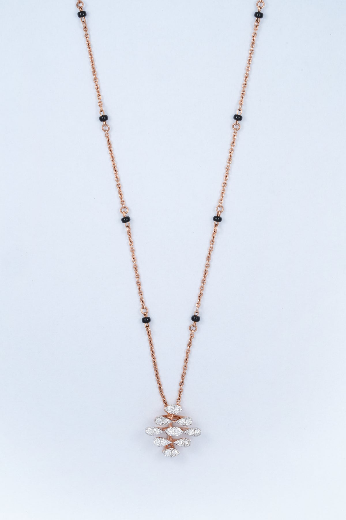 18KT rose gold diamond necklace with black bead accents and woven pendant