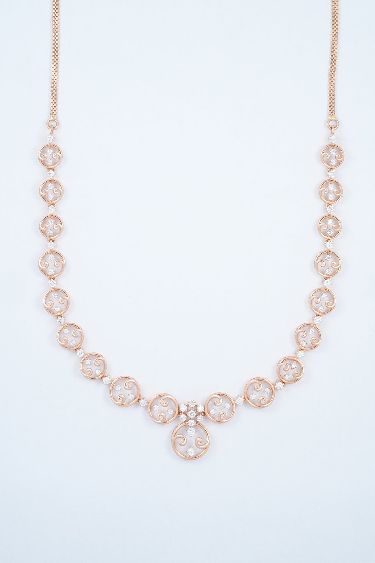 18KT rose gold diamond necklace with circle scroll link design