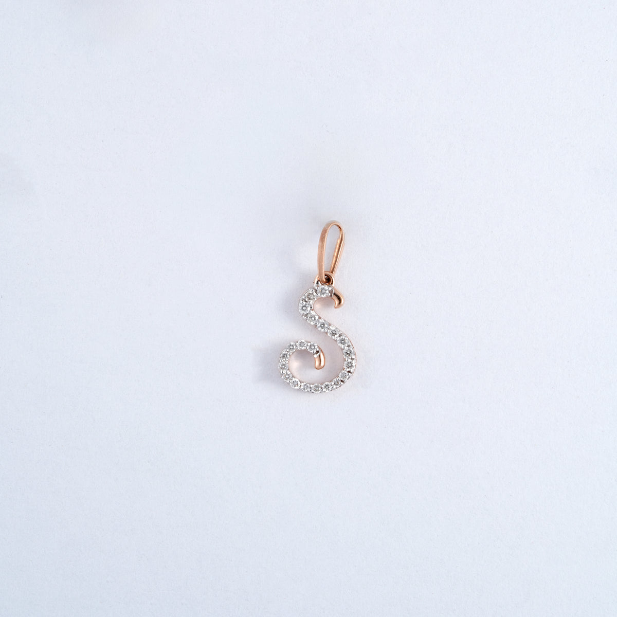 18KT rose gold pendant in the shape of the letter S with diamonds