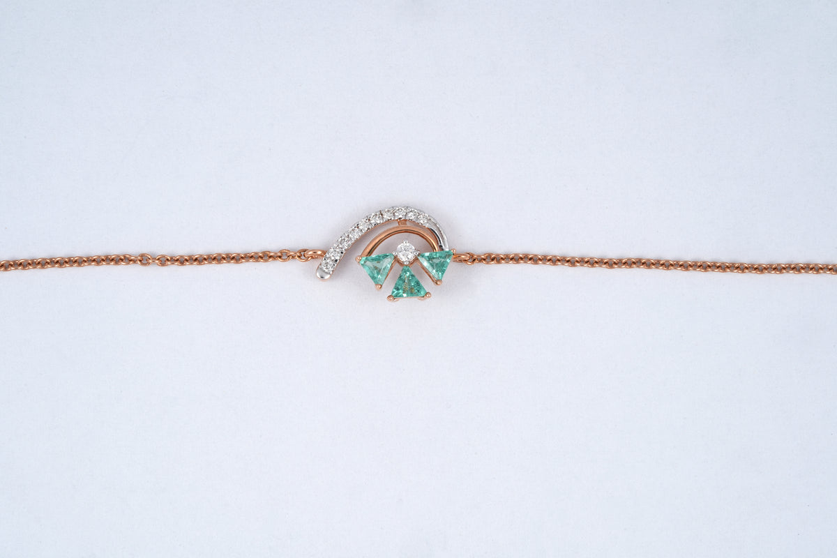 18KT rose gold bracelet with green gemstone cluster and diamond arc