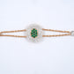 18KT rose gold bracelet with green gemstone cluster and diamond halo