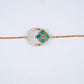 18KT rose gold bracelet with green gemstone clover and diamond crescent