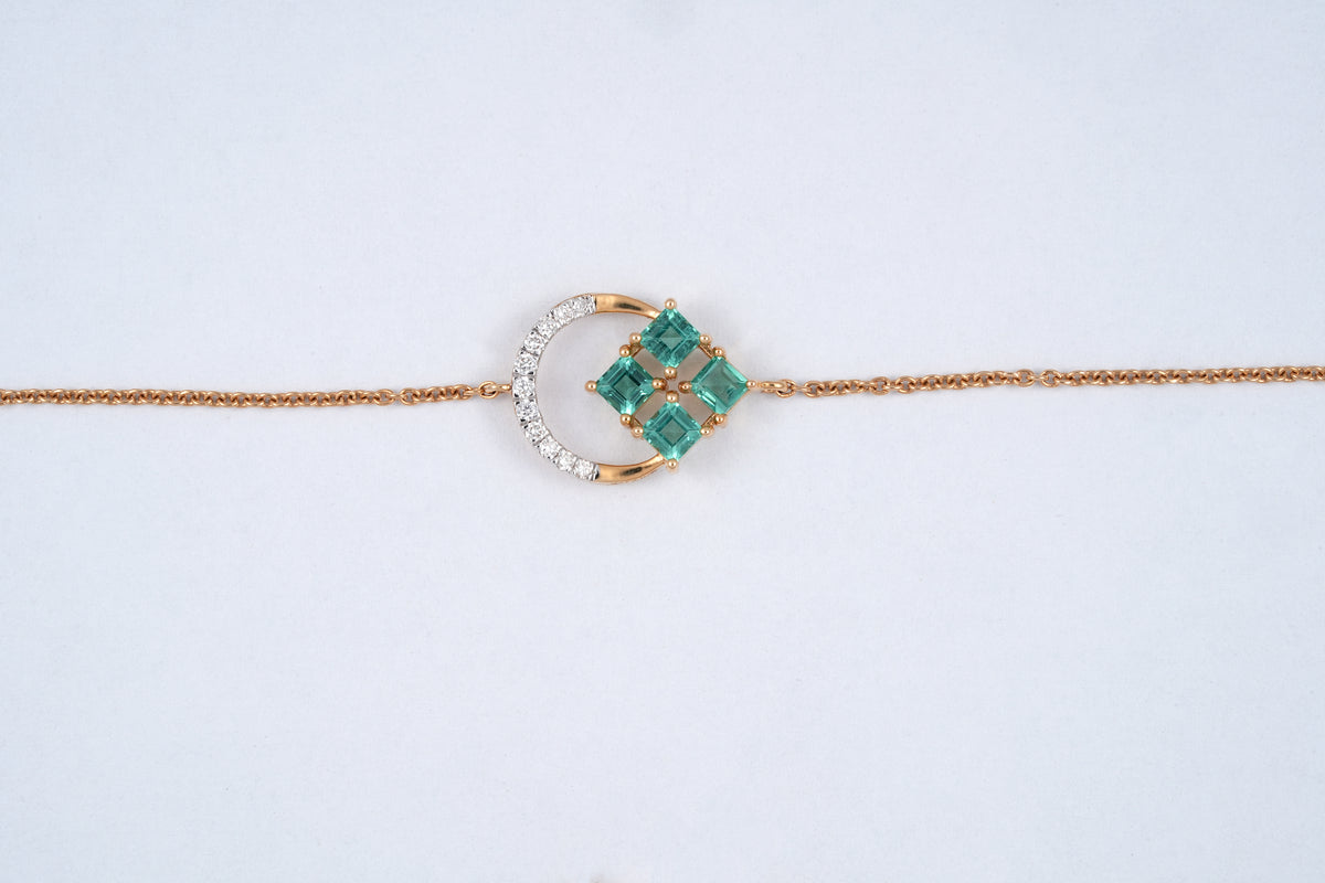 18KT rose gold bracelet with green gemstone clover and diamond crescent